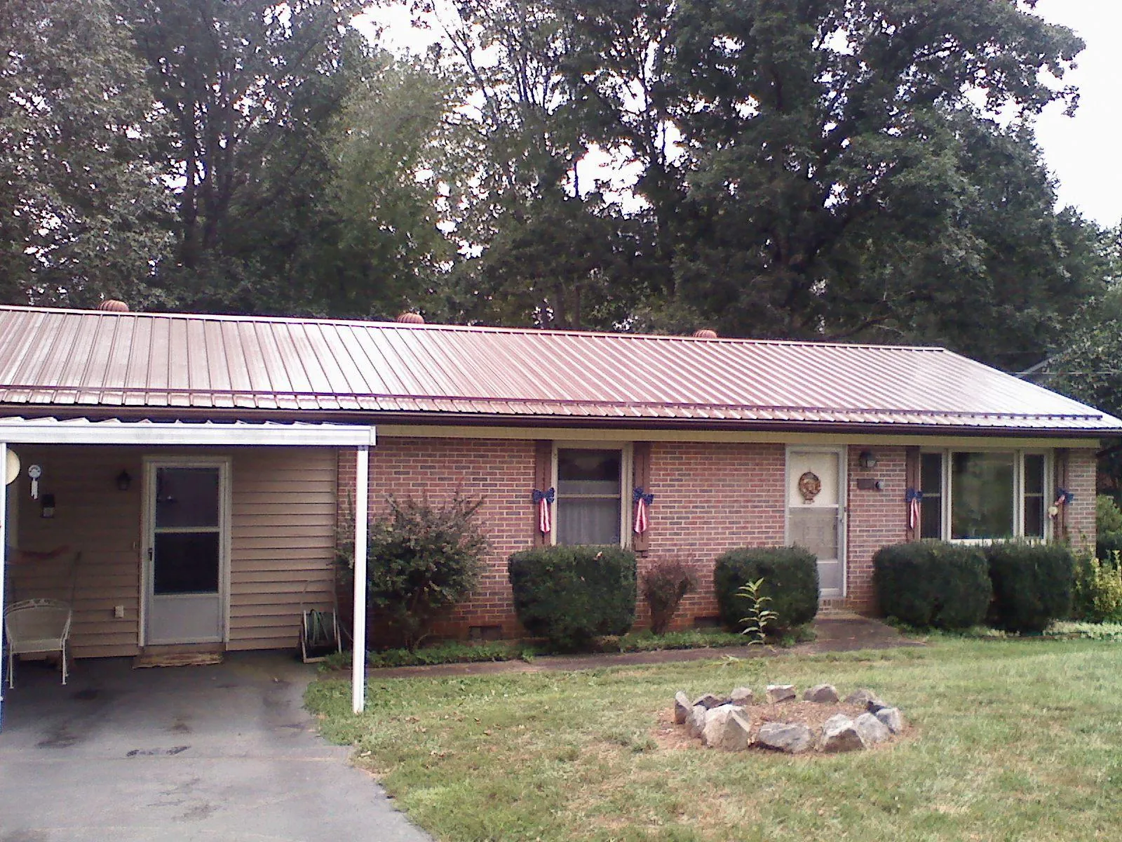 Bronze metal roof and carport on a brick ranch home — Roof Repair work by our crew in North Las Vegas